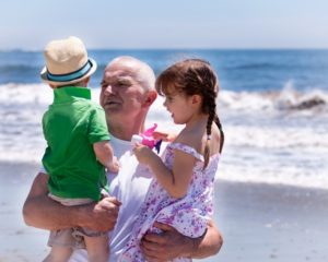 grandfather holding his grandkids